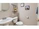 Charming powder room with pedestal sink and decorative wall art at 9066 Hilverson Ave, Las Vegas, NV 89148