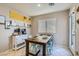 Cozy dining area with rustic table, surrounded by natural light at 9066 Hilverson Ave, Las Vegas, NV 89148