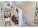 Welcoming entryway with decorative console table and carpeted stairs at 9066 Hilverson Ave, Las Vegas, NV 89148