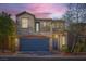 Charming two-story home featuring a blue garage door and a second-story balcony at 9066 Hilverson Ave, Las Vegas, NV 89148