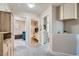 Hallway leading to bedroom and bathroom featuring storage cabinets and neutral walls at 9066 Hilverson Ave, Las Vegas, NV 89148
