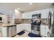 Updated kitchen boasts granite counters, stainless steel appliances and white cabinets at 9066 Hilverson Ave, Las Vegas, NV 89148