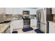 Bright kitchen featuring stainless steel appliances, granite counters and white cabinetry at 9066 Hilverson Ave, Las Vegas, NV 89148