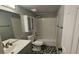 Clean bathroom with a shower-tub combo and storage cabinet at 928 Rockview Dr # 102, Las Vegas, NV 89128