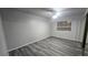 Cozy bedroom with wood-look flooring, ceiling fan, and a window at 928 Rockview Dr # 102, Las Vegas, NV 89128
