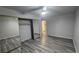 Bright bedroom featuring mirrored closet doors and wood-look flooring at 928 Rockview Dr # 102, Las Vegas, NV 89128