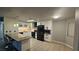 Open-concept kitchen with an island, bar stools, and sleek black appliances at 928 Rockview Dr # 102, Las Vegas, NV 89128