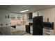 Modern kitchen boasts white cabinetry and sleek, black appliances at 928 Rockview Dr # 102, Las Vegas, NV 89128