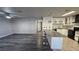 Living room showcasing new flooring, neutral paint, ceiling fan, and an open view into the renovated kitchen at 928 Rockview Dr # 102, Las Vegas, NV 89128