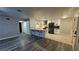 Open-concept living and kitchen area with updated flooring and white cabinets at 928 Rockview Dr # 102, Las Vegas, NV 89128