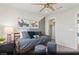 Stylish bedroom with a twin bed, gray blue bedding, overhead fan, and modern decor at 9671 S Conquistador St # Lot 18, Las Vegas, NV 89178