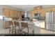 Spacious kitchen with an island, stainless steel appliances, and light wood cabinets at 9671 S Conquistador St # Lot 18, Las Vegas, NV 89178