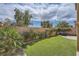 A backyard is landscaped with artificial turf, a paver patio, brick walls, and lush greenery at 11913 Alava Ave, Las Vegas, NV 89138