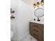 Stylish powder room with modern vanity, decorative mirror and tile floors at 11913 Alava Ave, Las Vegas, NV 89138