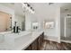 Bathroom with double sinks, a large mirror, a soaking tub, and a walk-in shower at 11913 Alava Ave, Las Vegas, NV 89138