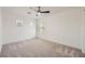 Bedroom with neutral carpet, three windows for ample natural light and a ceiling fan at 11913 Alava Ave, Las Vegas, NV 89138