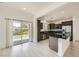 Modern kitchen featuring stainless steel appliances, dark cabinets, and an island with black granite countertops at 11913 Alava Ave, Las Vegas, NV 89138