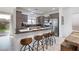 Modern kitchen with a breakfast bar, grey cabinets, and stainless steel appliances at 11913 Alava Ave, Las Vegas, NV 89138