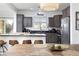 Well-equipped kitchen with grey cabinets, stainless appliances, and a cozy breakfast bar at 11913 Alava Ave, Las Vegas, NV 89138