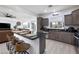 Modern kitchen with grey cabinets, stainless steel appliances, and an inviting breakfast bar at 11913 Alava Ave, Las Vegas, NV 89138
