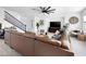 Spacious living room featuring a modern ceiling fan and a comfortable brown leather sectional sofa at 11913 Alava Ave, Las Vegas, NV 89138