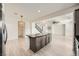 Open concept living and kitchen space with a spacious kitchen island and modern fixtures at 11913 Alava Ave, Las Vegas, NV 89138