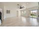 Large living room with wood floors, modern ceiling fan, recessed lighting, and sliding glass doors at 11913 Alava Ave, Las Vegas, NV 89138