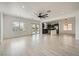 Bright, open-concept living area with wood floors and a view into the kitchen featuring stainless appliances at 11913 Alava Ave, Las Vegas, NV 89138