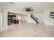 Bright, open-concept living area with wood floors and view into the kitchen featuring a center island at 11913 Alava Ave, Las Vegas, NV 89138