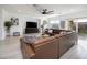 Bright and airy living room with a large brown leather sectional, perfect for entertaining at 11913 Alava Ave, Las Vegas, NV 89138