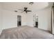 Bright main bedroom with carpet, a ceiling fan, and an ensuite bathroom at 11913 Alava Ave, Las Vegas, NV 89138