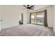 Spacious main bedroom with a ceiling fan, carpeted floors, and sliding glass doors to a balcony at 11913 Alava Ave, Las Vegas, NV 89138