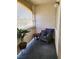 Enclosed balcony featuring a comfortable wicker chair, side table, and potted plant at 2725 S Nellis Blvd # 2083, Las Vegas, NV 89121
