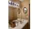 Bathroom with a white countertop, decorative mirrors, and updated fixtures at 2725 S Nellis Blvd # 2083, Las Vegas, NV 89121