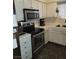 Kitchen with white cabinets, stainless steel appliances, and black hexagonal tile floors at 2725 S Nellis Blvd # 2083, Las Vegas, NV 89121