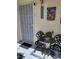 Cozy front patio with metal table and chairs, secured entry door, and welcoming decor at 2725 S Nellis Blvd # 2083, Las Vegas, NV 89121