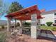 Community picnic area with shaded pergola, picnic tables, and a built-in grill at 2725 S Nellis Blvd # 2083, Las Vegas, NV 89121