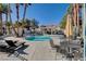 Community swimming pool with lounge chairs and palm trees at 2725 S Nellis Blvd # 2083, Las Vegas, NV 89121
