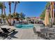 Inviting community pool with lounge chairs, tables, and umbrellas for relaxing poolside at 2725 S Nellis Blvd # 2083, Las Vegas, NV 89121