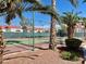 Community tennis court surrounded by palm trees and residential buildings at 2725 S Nellis Blvd # 2083, Las Vegas, NV 89121