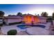 Private backyard featuring a pool, stone patio, and manicured landscaping, perfect for outdoor entertaining at 3008 Astoria Pines Cir, Las Vegas, NV 89107