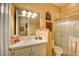 Well-lit bathroom with a shower, toilet, and vanity with picture frames decorating the wall at 3008 Astoria Pines Cir, Las Vegas, NV 89107