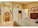 Inviting bedroom with a queen-sized bed, ensuite bathroom, and simple furnishings at 3008 Astoria Pines Cir, Las Vegas, NV 89107