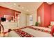 This bedroom has a bright red feature wall, and an ensuite entrance at 3008 Astoria Pines Cir, Las Vegas, NV 89107