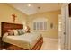 Comfortable bedroom with a wooden bed frame, shuttered window, and ensuite access at 3008 Astoria Pines Cir, Las Vegas, NV 89107