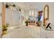 Bright foyer with tile floors, high ceilings, bar, and decor shelves create an inviting entrance at 3008 Astoria Pines Cir, Las Vegas, NV 89107
