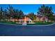 Elegant front exterior shows manicured lawn, mature trees and inviting walkway to the main entrance at 3008 Astoria Pines Cir, Las Vegas, NV 89107