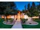 Charming front exterior features manicured landscaping, mature trees, and inviting walkway to front door at 3008 Astoria Pines Cir, Las Vegas, NV 89107