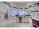 Gourmet kitchen with a central island, wine cooler, custom cabinets, and pantry access at 3008 Astoria Pines Cir, Las Vegas, NV 89107
