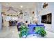 Open-concept living room with high ceilings, built-in entertainment center, and adjacent kitchen at 3008 Astoria Pines Cir, Las Vegas, NV 89107
